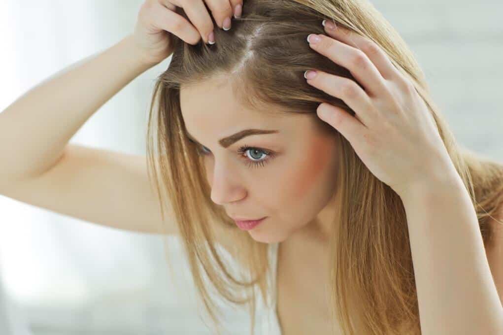 Woman checking scalp
