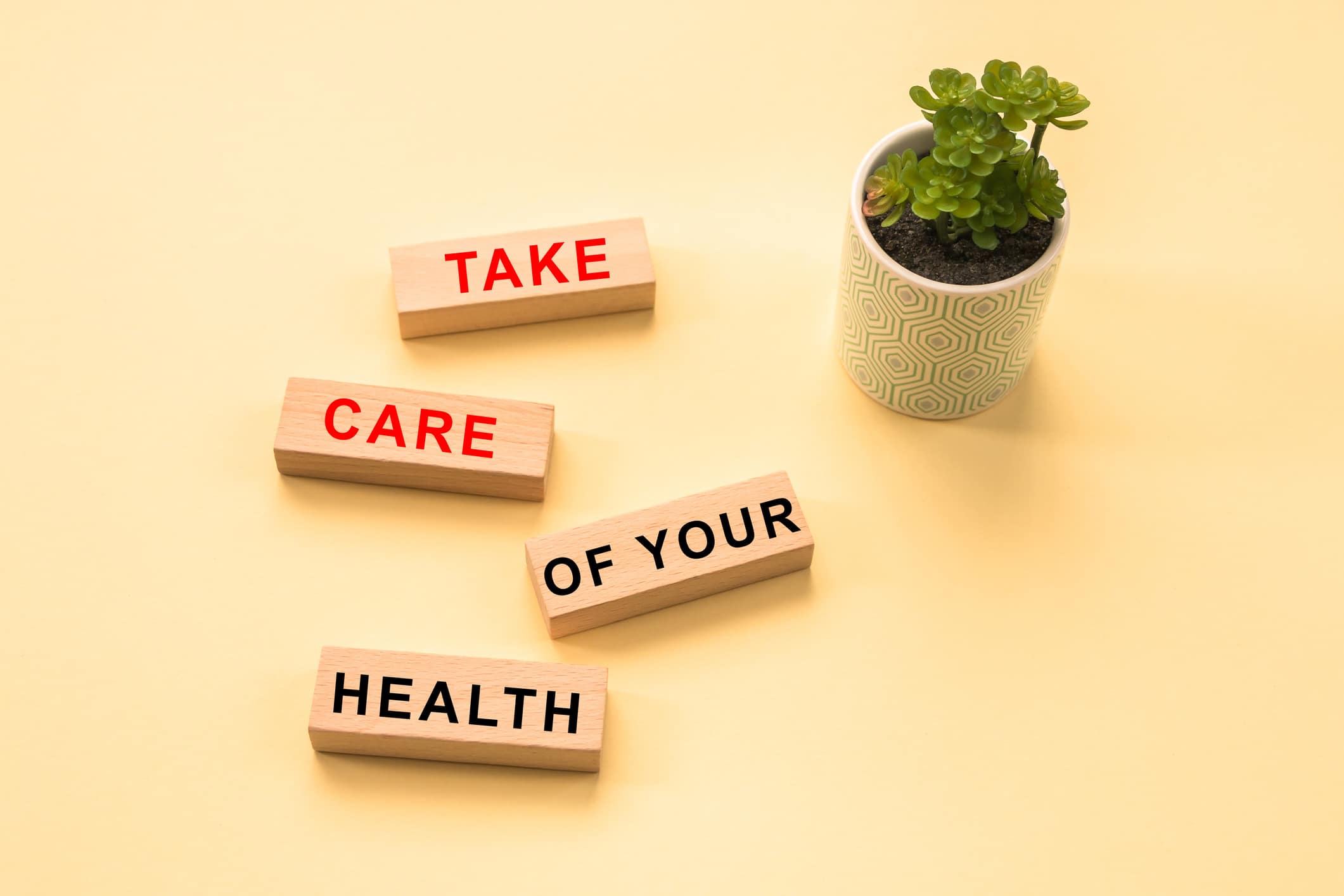 take care of your health. Text written on wooden cubes, flower on the right on a yellow background | ID:1458609098