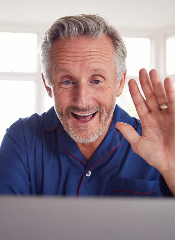 Mature Man Having Online Consultation With Doctor At Home On Laptop