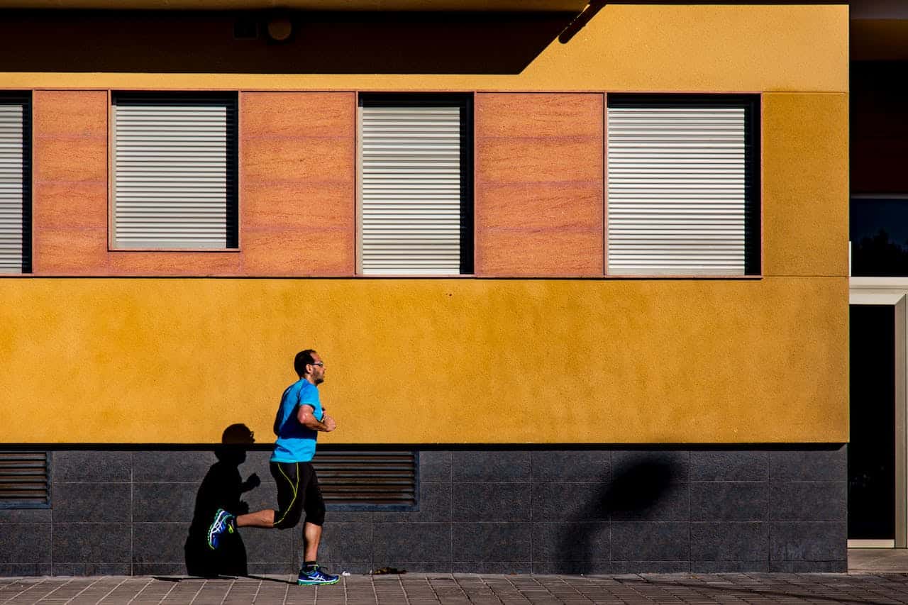 Photo of a man jogging during daytime by Carlos Perez