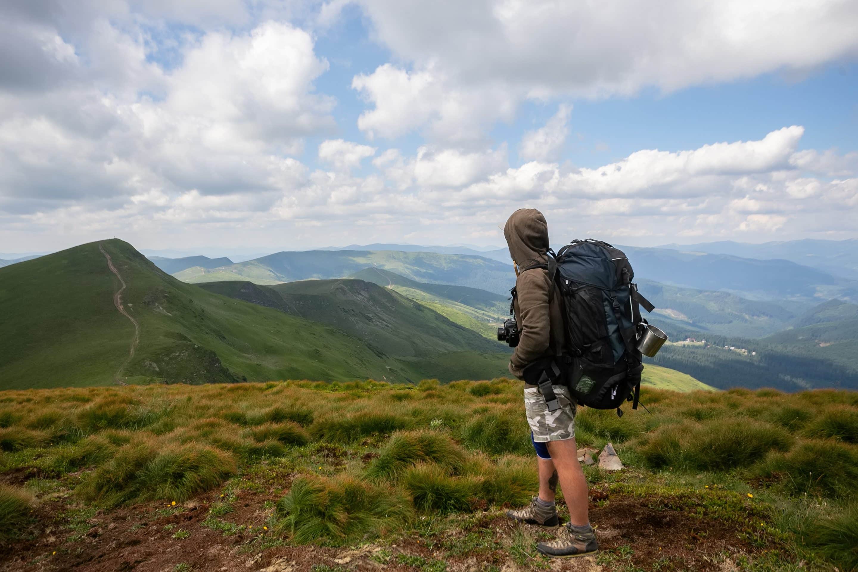 Man solo traveling backpacker hiking |